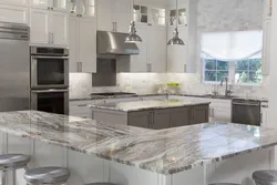 Gray kitchen in the interior with marble countertops