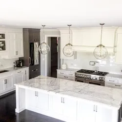 White kitchen design with marble countertops