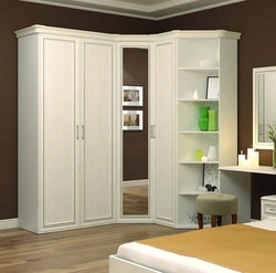 Photo of a corner wardrobe in the bedroom with a mirror