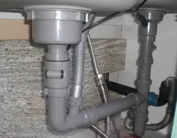 Pipe under the sink in the kitchen photo