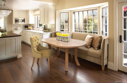 Photo of a kitchen with a sofa and table chairs