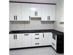 White glossy kitchen with black countertop photo