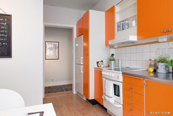 Kitchen design with orange refrigerator