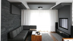Интерьер гостиной с угловым диваном и стенкой