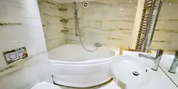 Bathroom design with a corner bathtub in light colors