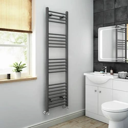 Heated towel rail in the bathroom interior