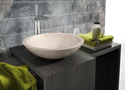 Photo of a bathtub with a bowl sink