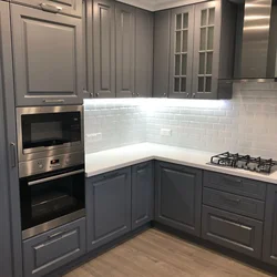 Gray kitchen with black countertop and apron in the interior