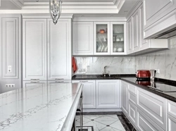 White kitchen with marble countertop and apron in the interior