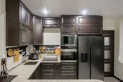 Photos of corner kitchens with built-in appliances and counter