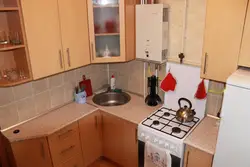 Kitchen design in Khrushchev with a gas water heater and a washing refrigerator