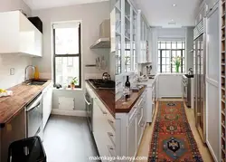 Photo of a narrow kitchen in a house with a window