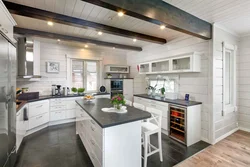 White kitchen in a wooden house in the interior