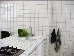 Grout on white tiles in the kitchen photo