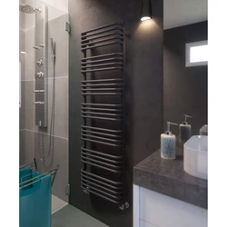 Black heated towel rail in the bathroom interior