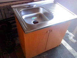 Overhead kitchen sink with cabinet photo