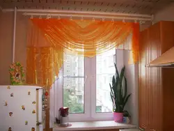 Photo of curtains for the kitchen if the wallpaper is orange