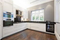 White kitchen design with brown countertops