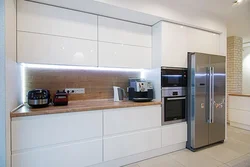 Refrigerator in a niche in the interior of the kitchen