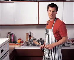 Мужчина готовит на кухне фото