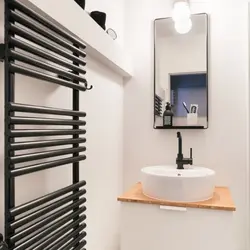 White heated towel rail for bathroom photo