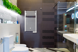 White heated towel rail for bathroom photo