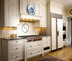 Photo of a beige kitchen with a hood