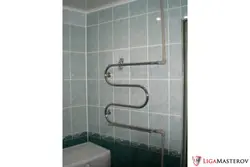 Heated towel rail in the bathroom photo in Khrushchev