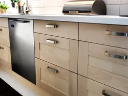 Black handles on a beige kitchen photo