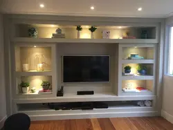 Wall of shelves in the living room photo