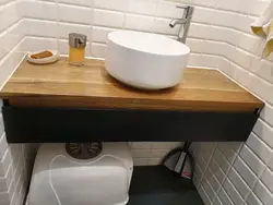 Shelf under the sink in the bathroom photo