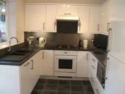 Black appliances in a beige kitchen photo