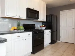 Black appliances in a beige kitchen photo