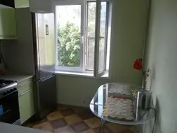 Refrigerator closes the window in the kitchen photo