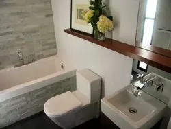 Toilet Between Bathtub And Sink Photo