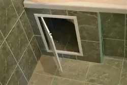 Hatch under the bathtub under the tiles photo