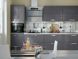 Photo of white kitchen with gray appliances