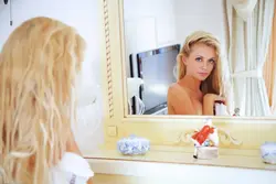 Photo of a blonde in a bathroom mirror
