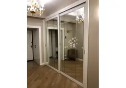 White mirrored wardrobe in the hallway photo