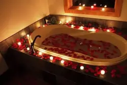 Bath with rose petals and candles photo