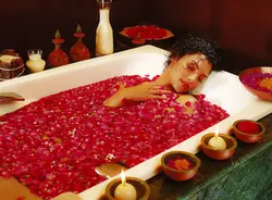 Bath with rose petals and candles photo