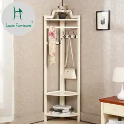 Coat rack in a small hallway with a mirror photo