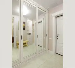 Narrow wardrobe in the hallway with a mirror photo