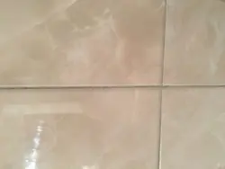 Grout for beige tiles in the bathroom photo