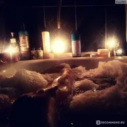 Photo in a bath with foam and a glass