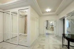White hallway wardrobe with mirror photo