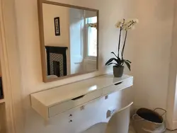 Mirror with a nightstand in the bedroom photo