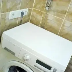 Socket in the bathroom for the washing machine photo