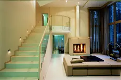 Photo of the living room interior with a fireplace and staircase