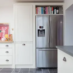 Refrigerator in a niche in the kitchen interior photo